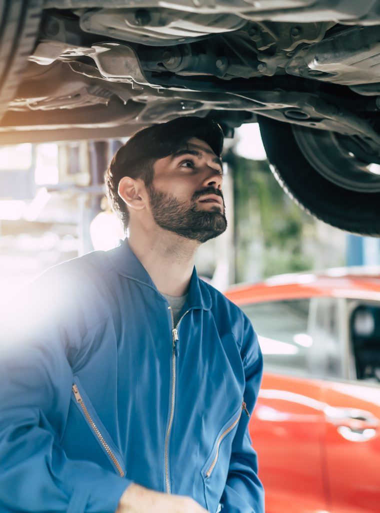 Mot Mechanic inspecting a vehicle during its test - MOT Reading